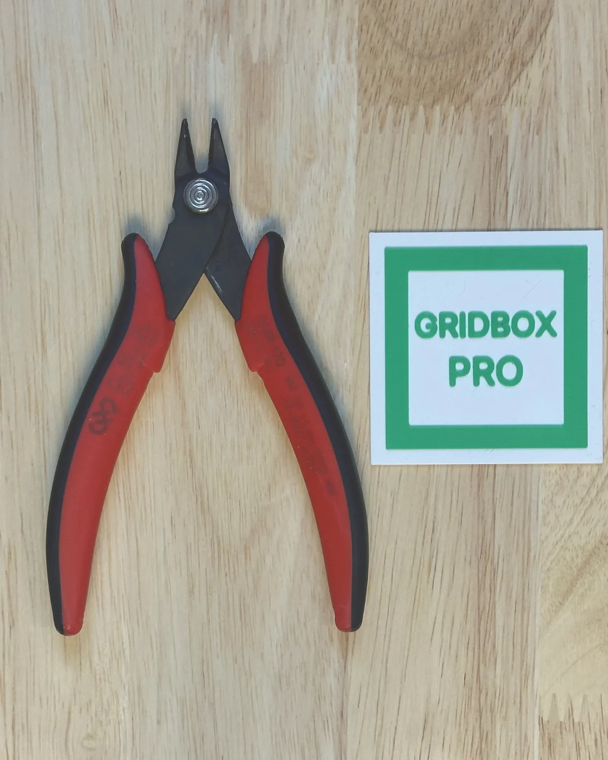 Wire cutters lying next to the printed scaler tile, photographed from above
